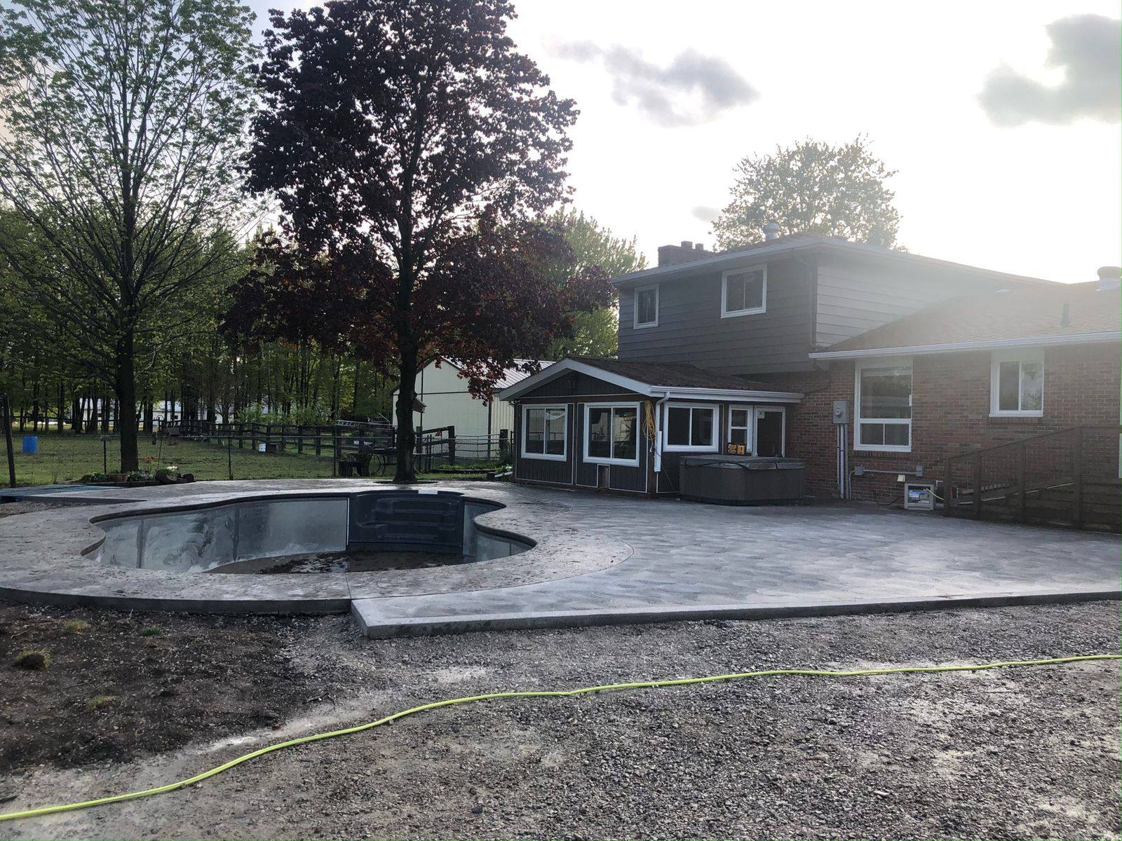 Curved concrete pool deck and patio