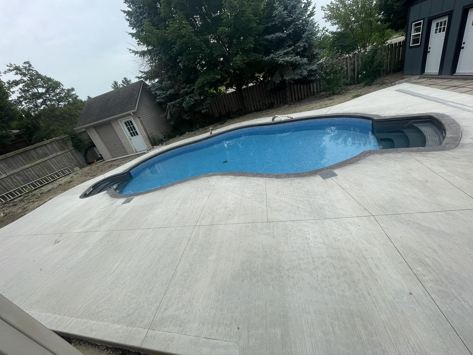 Full concrete pool surround on a large rural property