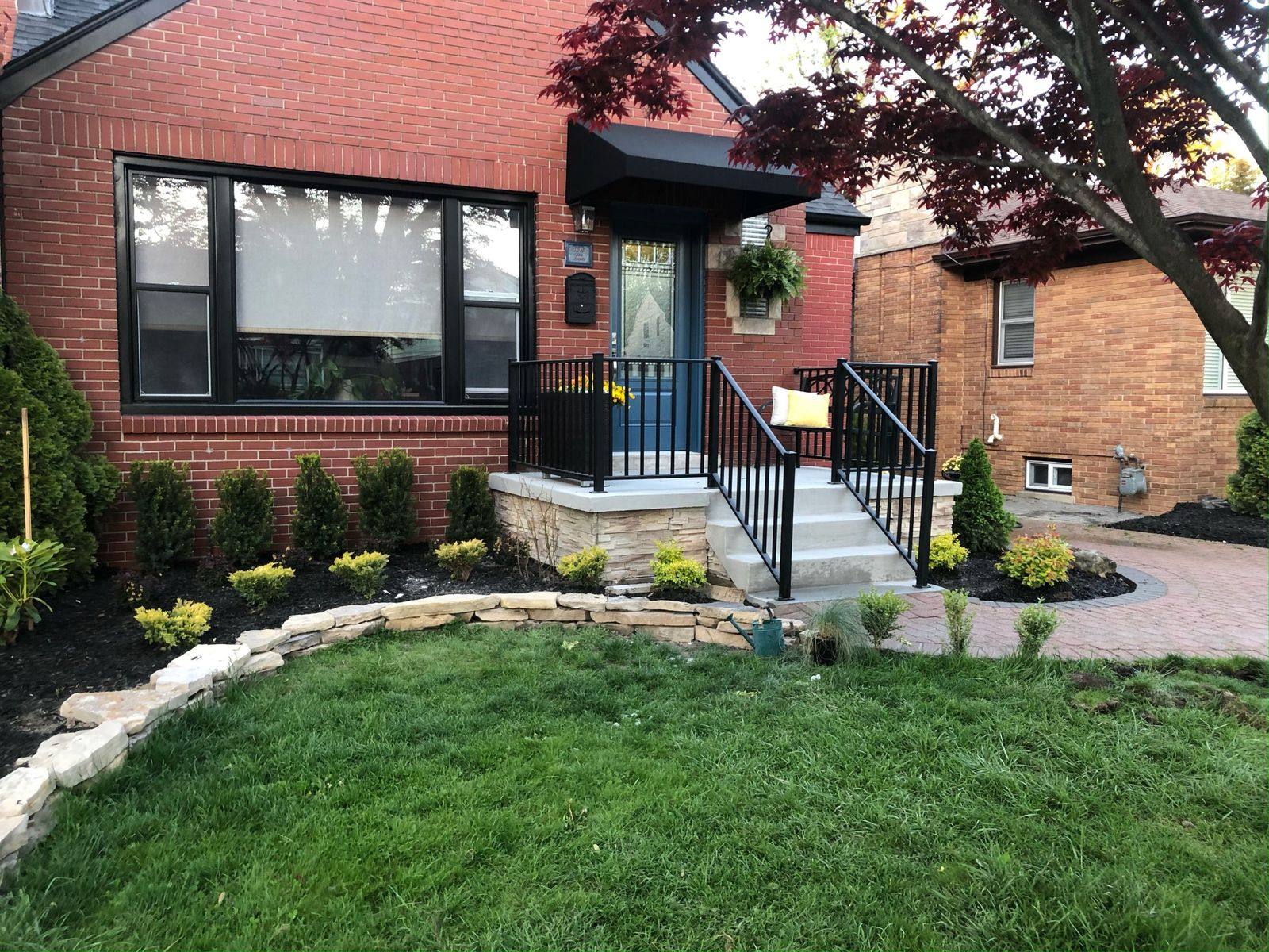 Concrete porch and steps at a brick home